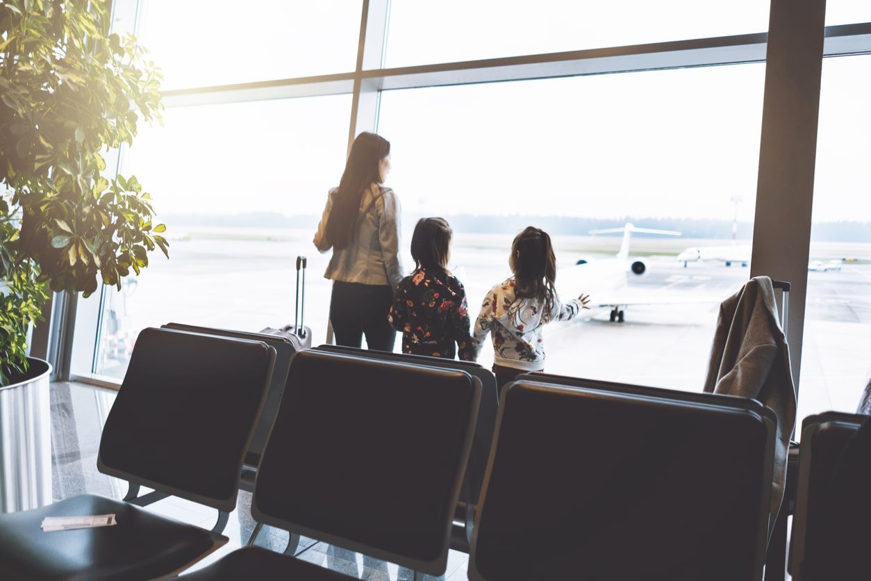 family waiting in airport to depart